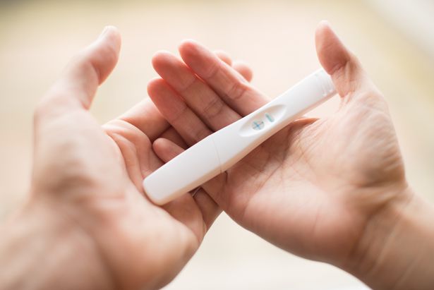 0_A-man-and-a-womans-hands-holding-together-a-pregnancy-test-revealing-the-positive-outcome-Pregna